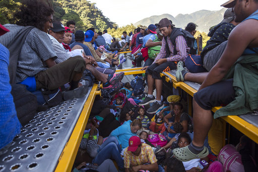 U.S.-bound Central American migrants begin their morning trek with a free ride on a truck, as part of a thousands-strong caravan leaving Cordoba, Veracruz state, Mexico, Monday, Nov. 5, 2018. A big group of Central Americans pushed on toward Mexico City from a coastal state Monday, planning to exit a part of the country that has long been treacherous for migrants seeking to get to the United States. [Photo: AP]