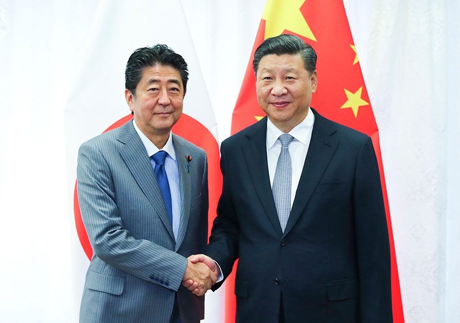 Xi, Abe meet on further improving China-Japan ties