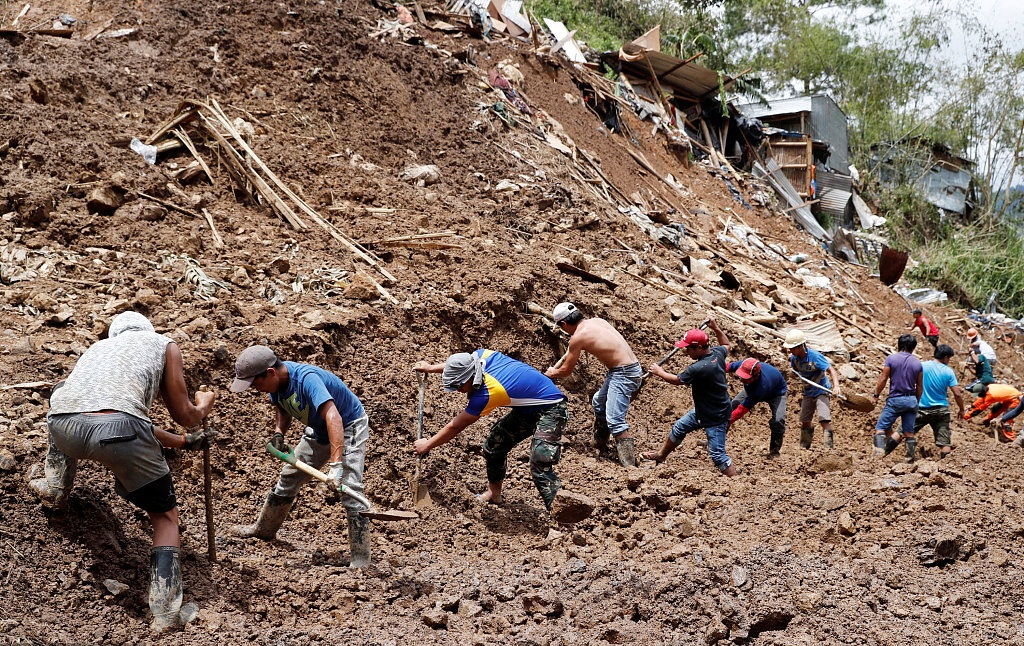 Dozens buried in landslides in Philippines after tropical storm 